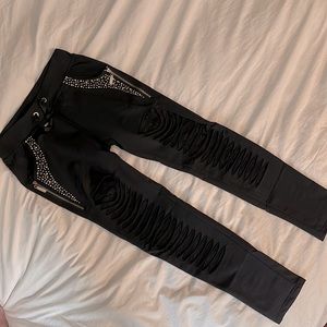 Distressed skinny pants with lace and gold studded pockets
